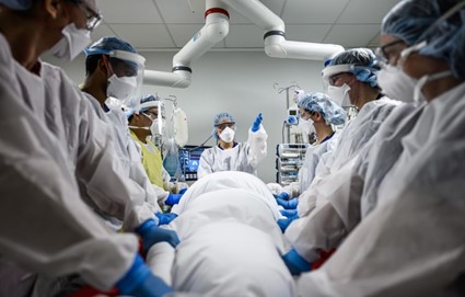 Doctors wearing masks attending to patient